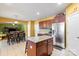 Open kitchen with stainless steel appliances, granite countertops, and wood cabinets connected to the dining area at 13502 Brandon Trail Dr, Charlotte, NC 28213