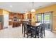 Spacious kitchen featuring wooden cabinets, a center island, stainless steel appliances, and a dining area at 13502 Brandon Trail Dr, Charlotte, NC 28213