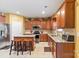 Cozy kitchen with wood cabinets, granite countertops, tile backsplash, and stainless steel appliances at 13502 Brandon Trail Dr, Charlotte, NC 28213