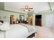 Large primary bedroom featuring a tray ceiling, ceiling fan, and plenty of natural light at 13502 Brandon Trail Dr, Charlotte, NC 28213