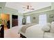 Spacious main bedroom featuring tray ceilings, soft green walls, and neutral carpeting at 13502 Brandon Trail Dr, Charlotte, NC 28213