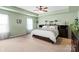 Serene primary bedroom with a ceiling fan, neutral color scheme, and ample closet space at 13502 Brandon Trail Dr, Charlotte, NC 28213