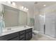 Bathroom featuring a double sink vanity and a glass-enclosed shower at 137 Sugar Magnolia Dr, Mooresville, NC 28115
