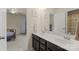 Well-lit bathroom featuring a double vanity, neutral decor, and access to an adjoining bedroom at 137 Sugar Magnolia Dr, Mooresville, NC 28115