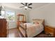 Cozy bedroom with hardwood floors, natural light, and a dresser at 137 Sugar Magnolia Dr, Mooresville, NC 28115