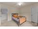 Charming bedroom with a twin bed, warm accents, and ample natural light from a large window at 137 Sugar Magnolia Dr, Mooresville, NC 28115