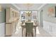 Dining room featuring hardwood floors, built in cabinet and chandelier with natural light from large windows at 137 Sugar Magnolia Dr, Mooresville, NC 28115