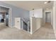 Bright hallway with neutral carpet, featuring a safety gate on the stairs and crisp, clean interior design at 137 Sugar Magnolia Dr, Mooresville, NC 28115