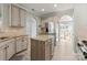 Open concept kitchen with granite countertops, stainless steel refrigerator, and island perfect for entertaining at 137 Sugar Magnolia Dr, Mooresville, NC 28115