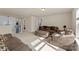 Spacious living room with comfortable seating, neutral carpet, and ample natural light from a skylight at 137 Sugar Magnolia Dr, Mooresville, NC 28115
