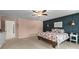 Inviting main bedroom featuring a bed with floral bedding, a striking accent wall, and cozy lighting at 137 Sugar Magnolia Dr, Mooresville, NC 28115