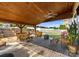 Covered outdoor patio features comfortable seating, area rug, ceiling fan and a lovely backyard at 137 Sugar Magnolia Dr, Mooresville, NC 28115