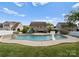 Well-maintained pool surrounded by lush green grass and featuring a basketball hoop for outdoor fun at 137 Sugar Magnolia Dr, Mooresville, NC 28115