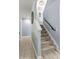 Carpeted staircase with natural lighting and a wall clock at 137 Sugar Magnolia Dr, Mooresville, NC 28115