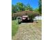 Exterior view of the open-air carport with an assortment of equipment at 143 Greenville Blvd, Bessemer City, NC 28016