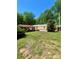 Charming single-story home with red-roofed carport and lush green lawn at 143 Greenville Blvd, Bessemer City, NC 28016