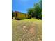 Yellow home with a red roof, wooden deck and overgrown lawn at 143 Greenville Blvd, Bessemer City, NC 28016