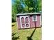 Red shed with double doors sitting on an overgrown lawn at 143 Greenville Blvd, Bessemer City, NC 28016