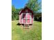 Charming red shed with a pair of double doors and an overgrown lawn at 143 Greenville Blvd, Bessemer City, NC 28016