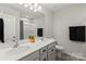 Bathroom with double sinks, a large mirror, and a shower/tub combo at 15622 Little Bluestem St, Charlotte, NC 28278