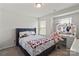 Bright bedroom featuring a bed, desk with lit mirror and two windows at 15622 Little Bluestem St, Charlotte, NC 28278