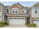 Charming home featuring a two-car garage, stone accents, and a mix of vinyl and shingle siding at 15622 Little Bluestem St, Charlotte, NC 28278