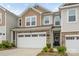 Charming home featuring a two-car garage, stone accents, and a mix of vinyl and shingle siding at 15622 Little Bluestem St, Charlotte, NC 28278