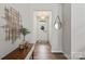 Inviting home foyer with wood flooring, modern decor, and a view of the front door at 15622 Little Bluestem St, Charlotte, NC 28278