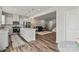 Open-concept kitchen with a large island, stainless steel appliances, and seamless flow into the living area at 15622 Little Bluestem St, Charlotte, NC 28278