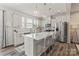 Bright open kitchen with stainless steel appliances and a large island, perfect for cooking and entertaining at 15622 Little Bluestem St, Charlotte, NC 28278
