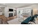 Open-concept living room featuring a fireplace, view into the kitchen, and modern furnishings at 15622 Little Bluestem St, Charlotte, NC 28278