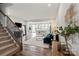 Inviting living room open to the modern kitchen, featuring hardwood floors and stairs leading to the second floor at 15622 Little Bluestem St, Charlotte, NC 28278