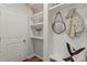 Well-organized mudroom featuring built-in shelves, coat hooks, and seating with a modern design at 15622 Little Bluestem St, Charlotte, NC 28278