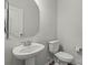 Cozy half bathroom features a pedestal sink, toilet, and fresh, neutral paint at 15622 Little Bluestem St, Charlotte, NC 28278