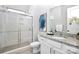 Well-lit bathroom with shower, granite countertop vanity, and modern fixtures at 16012 Tulloch Rd, Charlotte, NC 28278