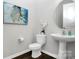 Stylish half-bathroom with modern fixtures including a vessel sink, round mirror, and elegant wall art at 16012 Tulloch Rd, Charlotte, NC 28278