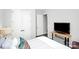 Bright bedroom featuring contemporary furnishings, a mounted television, and a closet at 16012 Tulloch Rd, Charlotte, NC 28278