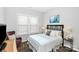 Inviting bedroom featuring large windows, side tables and a decorative headboard at 16012 Tulloch Rd, Charlotte, NC 28278