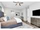 Bright bedroom with a ceiling fan, desk, walk-in closet, and en-suite bathroom at 16012 Tulloch Rd, Charlotte, NC 28278