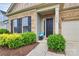 Charming home entrance with brick and siding, lush landscaping, and a cozy bench at 16012 Tulloch Rd, Charlotte, NC 28278