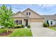 Charming brick home with a two-car garage, lush landscaping, and a welcoming entrance at 16012 Tulloch Rd, Charlotte, NC 28278