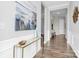 Elegant hallway featuring hardwood floors, decorative console table, and neutral wall colors at 16012 Tulloch Rd, Charlotte, NC 28278