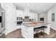 Stylish kitchen featuring modern appliances, an island with seating, and sleek white cabinetry at 16012 Tulloch Rd, Charlotte, NC 28278
