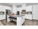 Modern kitchen with white cabinetry, stainless steel appliances, and a spacious center island at 16012 Tulloch Rd, Charlotte, NC 28278