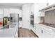 Well-equipped kitchen with stainless steel appliances, white cabinets, and modern fixtures at 16012 Tulloch Rd, Charlotte, NC 28278