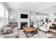 Inviting living room featuring a fireplace, gray sofa, and views to the kitchen at 16012 Tulloch Rd, Charlotte, NC 28278