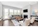 Cozy living room with a fireplace, hardwood floors, and ample natural light, creating a welcoming atmosphere at 16012 Tulloch Rd, Charlotte, NC 28278