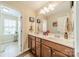 Bathroom with dual vanity, ample counter space, and decorative mirror at 16507 Palisades Commons Dr, Charlotte, NC 28278