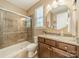 Cozy bathroom featuring a walk-in shower, granite vanity top, and decorative mirror at 16507 Palisades Commons Dr, Charlotte, NC 28278