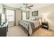 Bedroom with two bright windows, neutral walls, and simple decor at 16507 Palisades Commons Dr, Charlotte, NC 28278